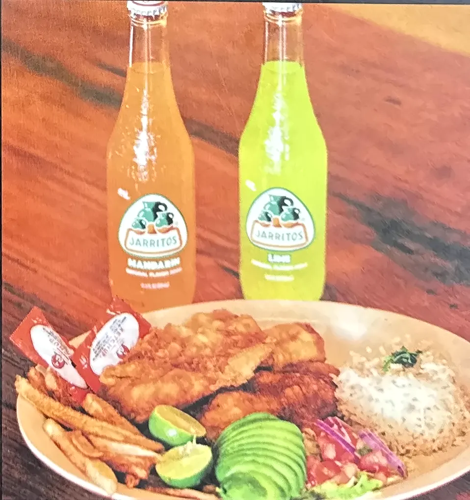 Breaded fish fillet plate with two sodas