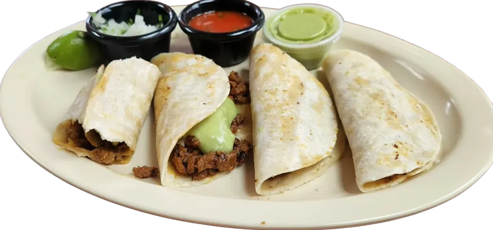 Plate of four tacos al pastor with cups of salsa and lime